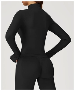 Detail view of the seamless black yoga jacket and leggings showing back fit and stretch