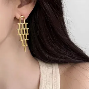 Golden geometric trapezoid tassel earrings with metallic tiered fringe for women
