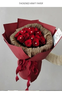 Detail of red roses with pearls wrapped in thick waterproof kraft paper bouquet layers