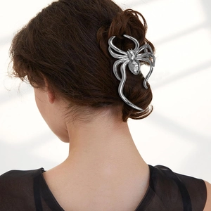 Silver metal spider hair claw clip detail on hair for a sleek Halloween accessory