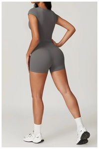 Detail showing the sculpting fit of high-waist grey yoga shorts and short sleeve top set