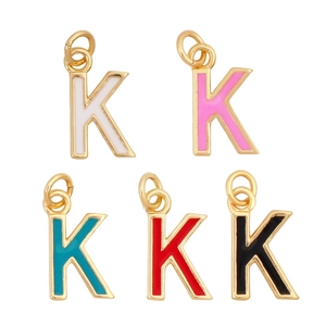 Macro shot of letter K pendants in gold finish with colorful enamel inlay options