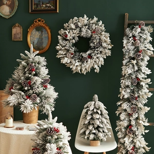 Flocked Christmas tree set with pine cones and red berries on a wooden base