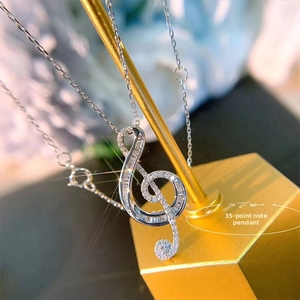 Macro shot of musical G-clef pendant necklace with 0.35ct pavé set zircons detail