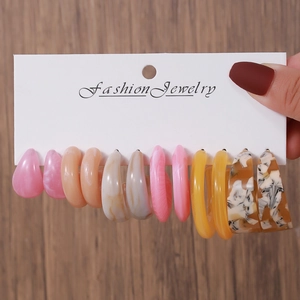 Set of six pairs of colorful acrylic C-shape hoop earrings on a fashion jewelry card