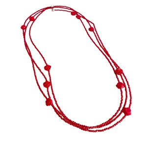 Three-layer red beaded necklace featuring elegant rose flower pendant on white background