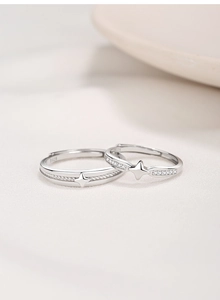 Macro shot of S925 sterling silver couple rings showing four-pointed star and zircon stones