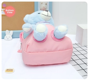 Detail of pink toddler backpack with a cute blue plush bear and waterproof nylon fabric