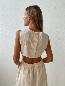 Detail of light beige two-piece set featuring back button closure and crinkled fabric texture