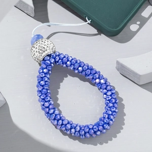 Detail of bright blue beaded phone strap with crystal faceted beads and pavé rhinestone ball
