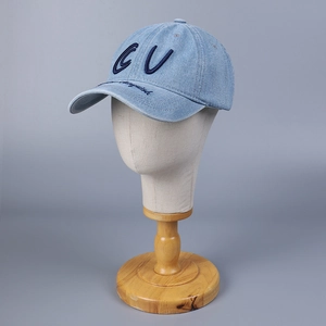 Light blue denim baseball cap with vintage CU embroidery and curved brim on display