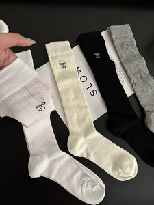 Close-up of breathable knit cotton socks with bow embroidery and vertical stripe texture
