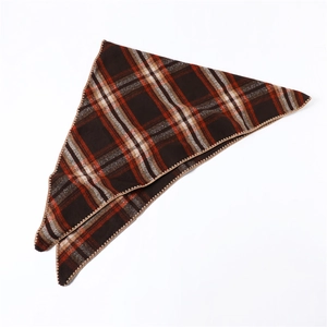 Detailed view of the dark brown plaid pattern and overlocked edges of the winter shawl