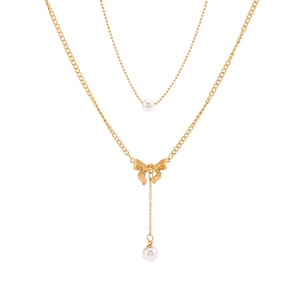 Double-layered gold bow necklace featuring elegant pearl pendants on a dual chain design
