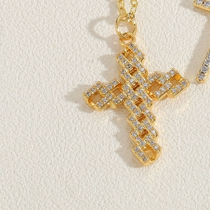 Macro shot of 14K gold-plated 3D hollow cross necklace with micro-pave cubic zirconia