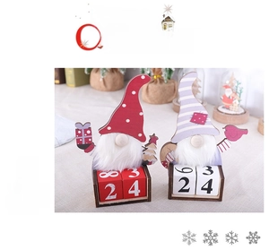 Detail of Christmas wooden gnome calendar with movable date blocks and felt hats