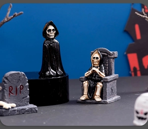 Detailed Halloween decor featuring skeleton figures and a RIP tombstone on display
