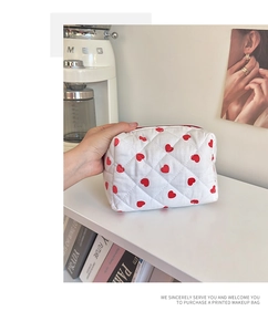Close-up of quilted heart makeup bag on a shelf with elegant home decor accessories