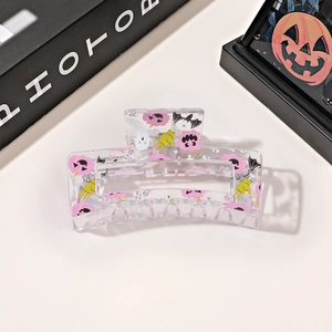 Detail of Halloween hair claw clip with cartoon pumpkin and ghost prints on acrylic
