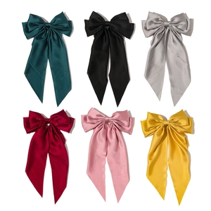 Elegant satin bow hair clips in six colors including green, black, and red for women