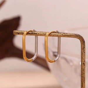 Minimalist oval gold and silver two-tone hoop earrings in polished stainless steel