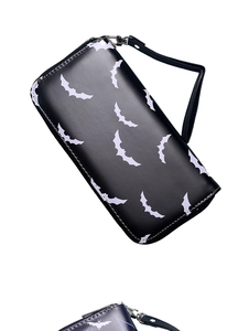 Detail view of the vintage bat print on the black long wallet with wrist strap attachment