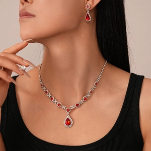 Luxury vintage jewelry set with red water drop crystals on model showing necklace and earrings