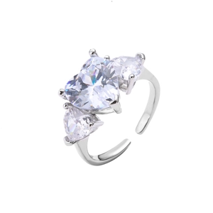 Macro detail of silver adjustable ring featuring three sparkling heart-shaped zircon stones