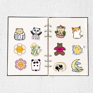 Close-up of cute cartoon animal and plant stickers neatly arranged on a white notebook