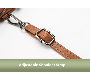 Detail of adjustable caramel leather strap with gunmetal hardware and precise stitching