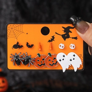 Halloween earring set with pumpkin bat and spider charms on dark display card