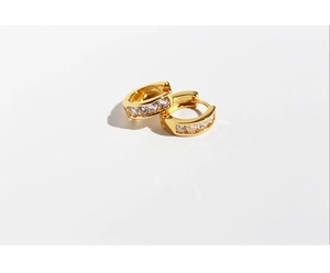 Detailed close-up of gold-plated hoop earrings with inlaid sparkling zircon stones