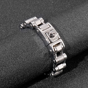 Macro detail of men's skull bike chain bracelet showing knurled texture and polished steel