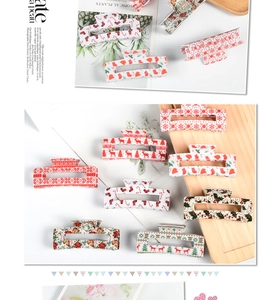 Detailed view of festive Christmas hair claws with reindeer and snowflake patterns