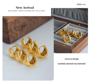 Detailed view of U-shaped gold earrings with hollow retro textures on wooden jewelry box