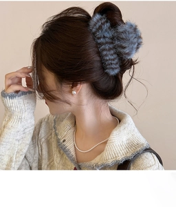 Close-up of a blue plush striped claw clip in hair, perfect for elegant autumn winter styles