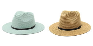 Detail showing handwoven texture and black ribbon on straw Panama beach hats