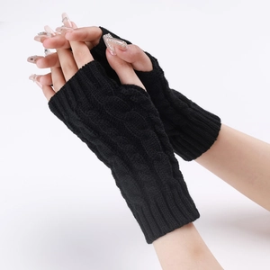 Close-up of black cable-knit arm warmers featuring fingerless design and soft texture