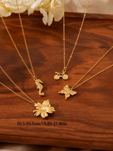 Detail of gold stainless steel necklaces with seahorse and flower pendants on wooden tray