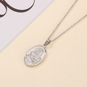 Macro shot of silver oval pendant featuring Virgin Mary and Child on a steel chain