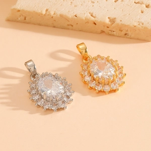 Oval crystal pendants in silver and gold titanium steel on a natural rock background