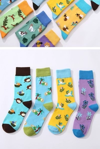 Detail showing colorful cotton crew socks with animal and floral patterns on white background