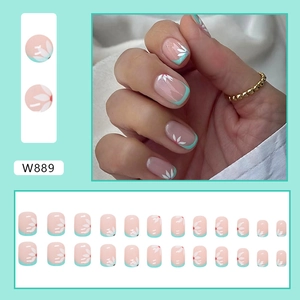 Short round press-on nails set with pink base, mint green tips and white flower patterns