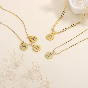 Gold letter pendant necklaces with zircon inlay on different chain styles shown with decor