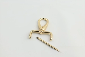 Detail of shiny gold lobster clasp with detachable screw bar for handbag straps