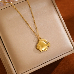 Close-up of golden tropical fish pendant on O-chain displayed in a premium jewelry gift box