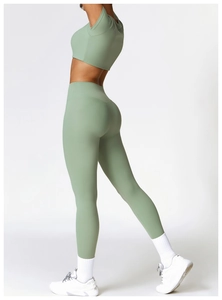 Sage green high-waist yoga pants and crop top set shown from a side-back view