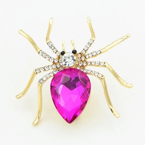 Elegant gold spider brooch with large pink crystal teardrop and sparkling rhinestones