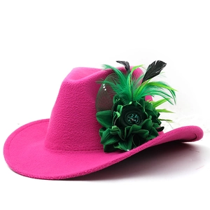 Detail view of pink wool fedora with large green satin flower and feather accents