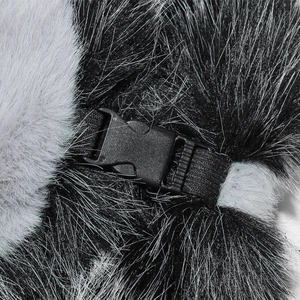Detail of adjustable black plastic buckle and strap on thick faux fur winter hat